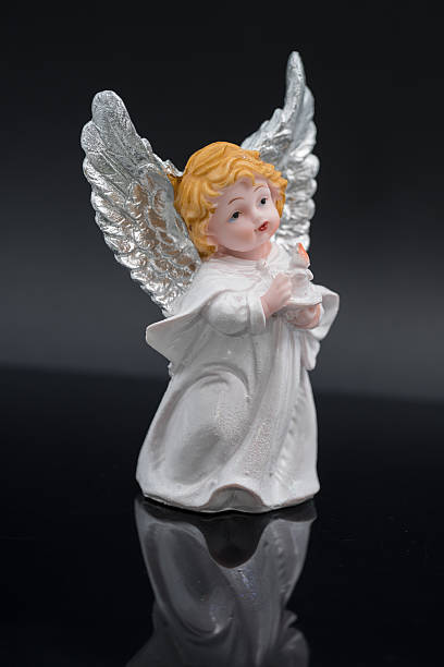 istock white angel trinket on a black background 2215147085