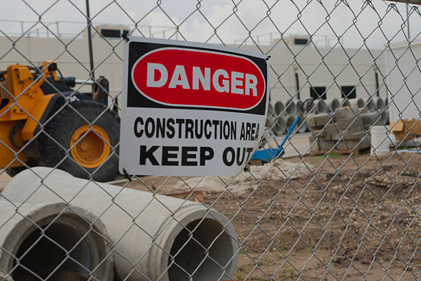 istock Danger Sign Warning Keep Out at Construction Site Behind Chain Link Fence. 2215149164