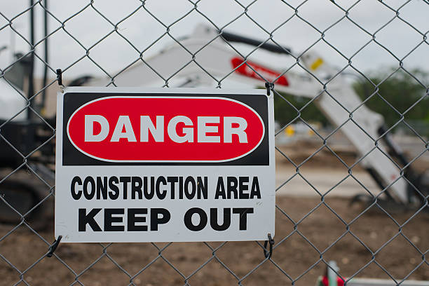 istock Danger Sign Warning Keep Out at Construction Site Behind Chain Link Fence. 2215149166