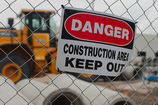 istock Danger Sign Warning Keep Out at Construction Site Behind Chain Link Fence. 2215149316