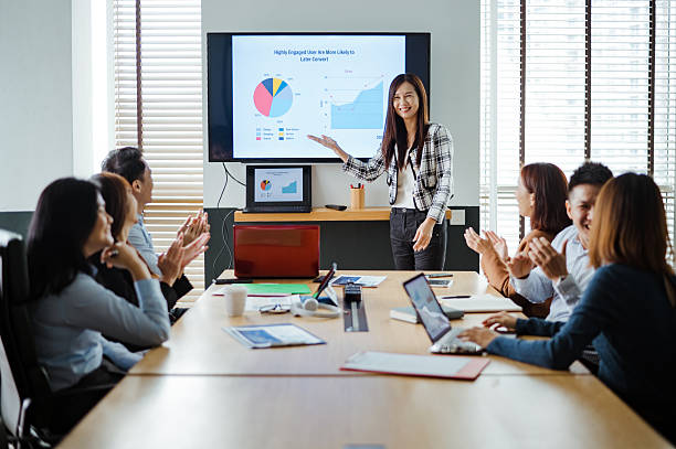 istock Diverse business professionals applauding a presentation on financial performance in a modern office environment. 2215154932