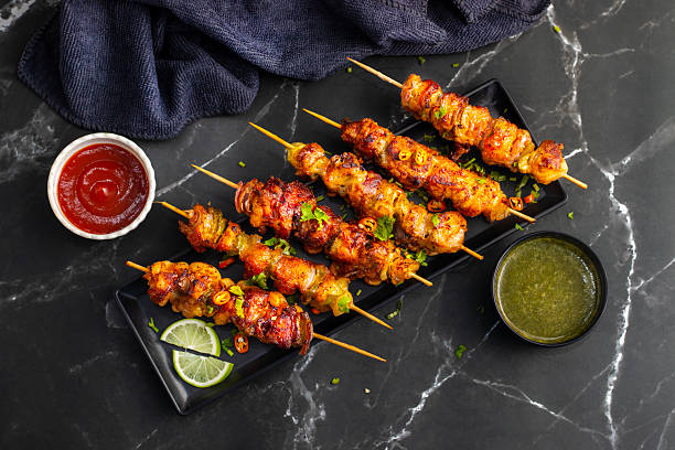 istock Chicken satay is grilled, marinated chicken skewers served with a rich, savory peanut sauce, popular in Southeast Asian cuisine. 2215158646