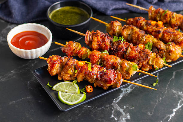 istock Chicken satay is grilled, marinated chicken skewers served with a rich, savory peanut sauce, popular in Southeast Asian cuisine. 2215158670