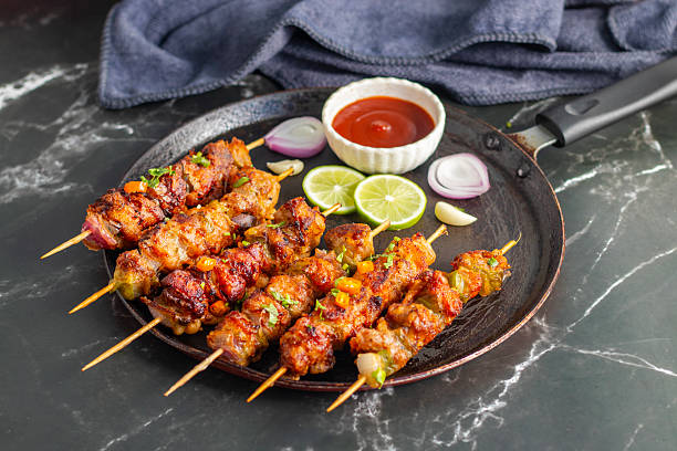 istock Chicken satay is grilled, marinated chicken skewers served with a rich, savory peanut sauce, popular in Southeast Asian cuisine. 2215158703