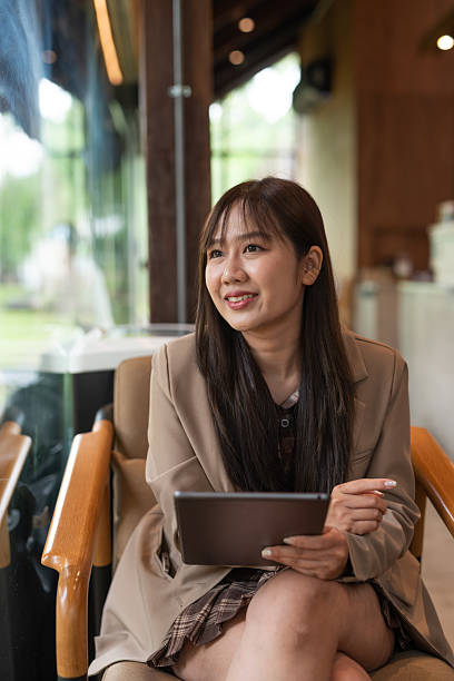 istock young woman with tablet computer in cafe 2215161028
