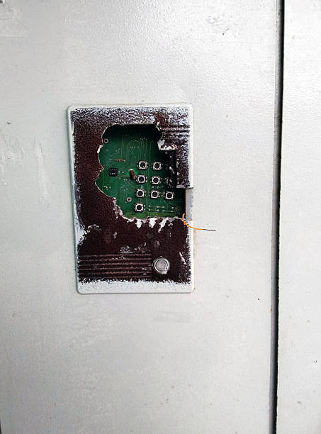 The door of an apartment building with a broken intercom.