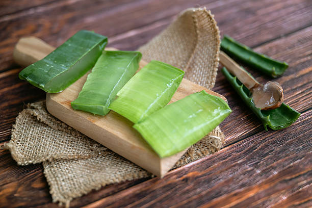 istock Aloe vera fresh leaves on wooden background 2215165364