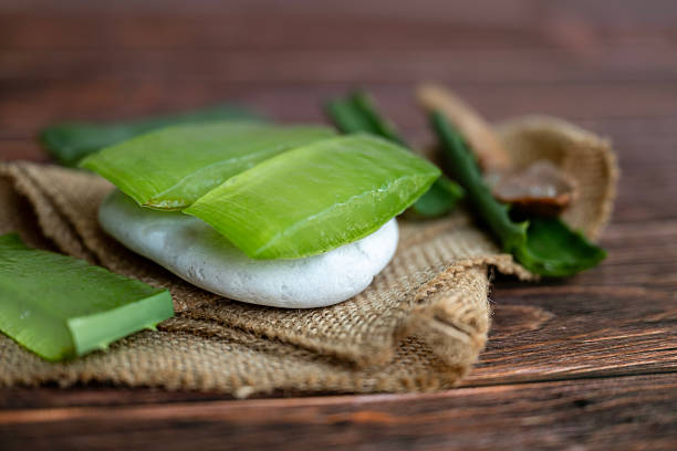 istock Aloe vera fresh leaves on wooden background 2215165380