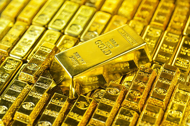 istock Large gold bars with golden light on stacking small gold bar 2215166676