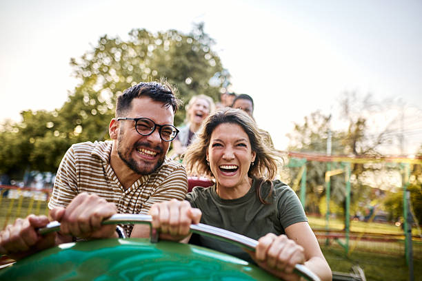 istock Cheerful couple riding on rollercoaster at amusement park. 2215166984