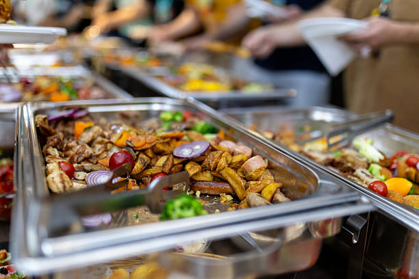 istock Buffet-style spread featuring assorted dishes and vibrant vegetables at a lively gathering 2215169322