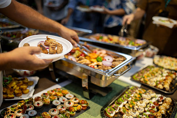 istock Delicious buffet spread featuring assorted dishes at a gathering with guests enjoying food 2215169328