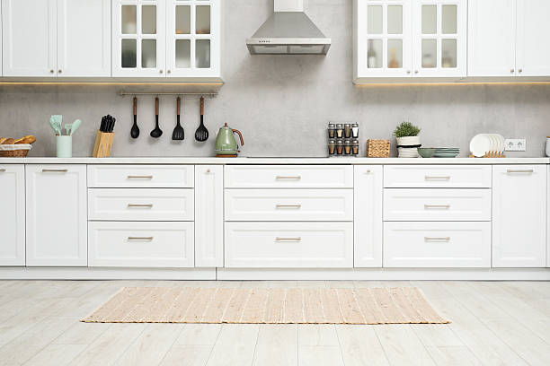 istock Stylish soft rug on wooden floor in kitchen 2215169890