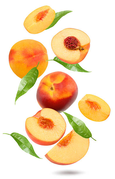 istock flying nectarine with green leaves isolated on white background. clipping path 2215170604