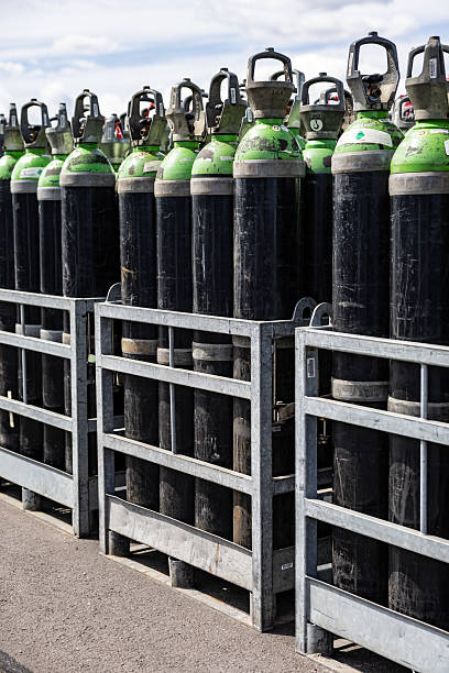 istock Compressed Gas Cylinders Stored Outdoors in Metal Crates 2215172097