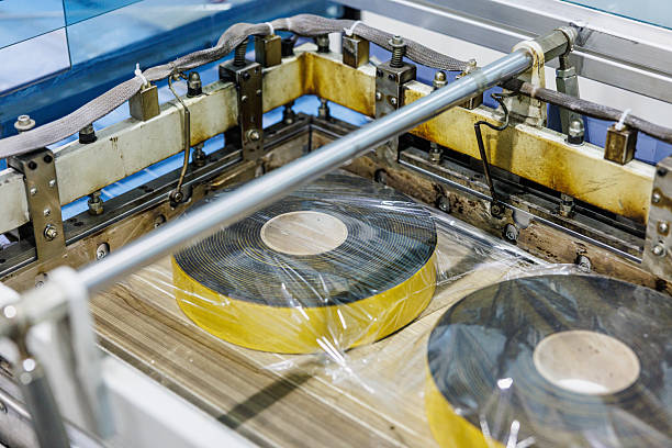 Electrical insulation tape rolls packed coming out of the conveyor machine, small business manufacturing and warehouse