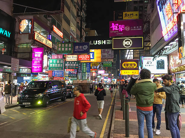 Hong Kong, Hong Kong - 12 05 2017: Hong Kong crowded street neon lights billboard advertisement night.