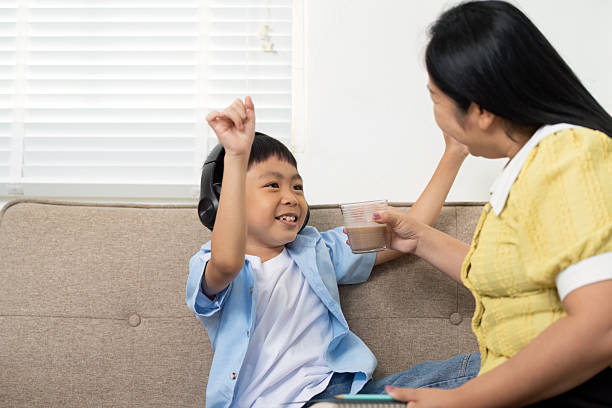 istock Back to School: Boy Celebrating Learning Moment with Caregiver 2215175160