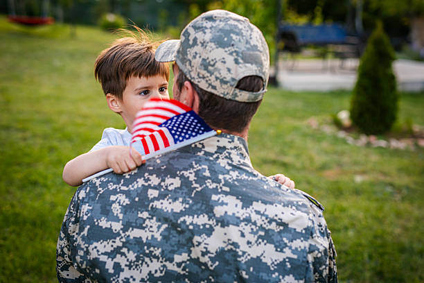 istock American soldier father returning from the army hugging his son 2215175808