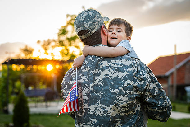 istock American soldier father returning from the army hugging his son 2215175826