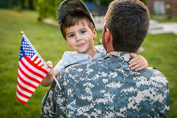 istock American soldier father returning from the army hugging his son 2215175832