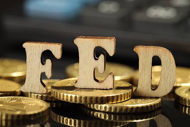 istock Letters Fed (Federal Reserve System) and coins on mirror table, closeup 2215176225