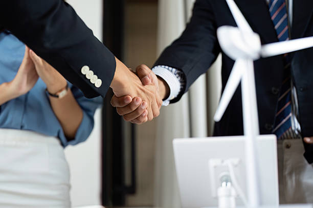 istock Sustainability and ESG. Business professionals shaking hands in a modern office setting. 2215176293