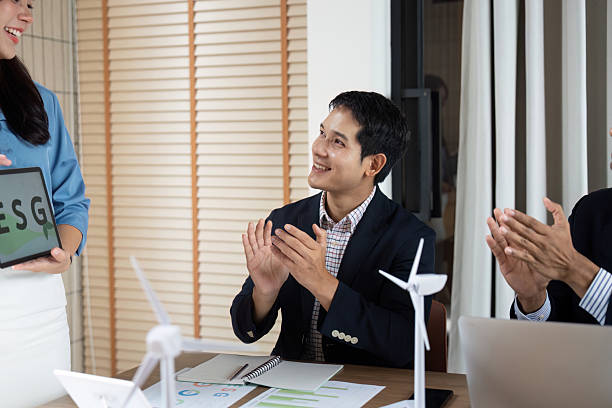 istock Sustainability and ESG. Team celebrating successful presentation on environmental initiatives. 2215176468