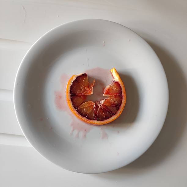 istock One round torn slice of red juicy orange 2215176845
