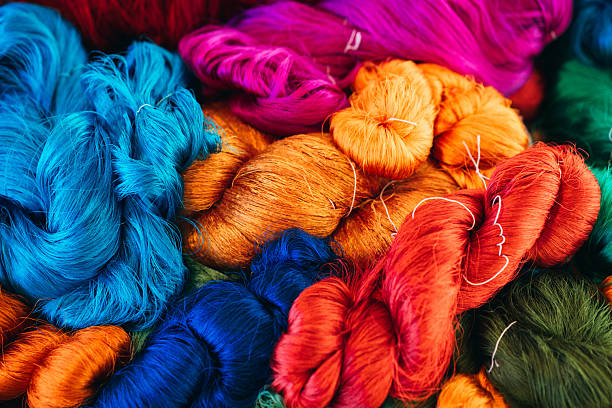 istock Colorful silk threads and dyeing with raw materials, traditional Thai sericulture in the countryside. 2215177293