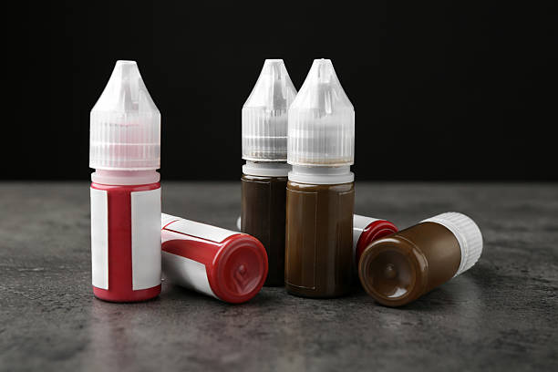 istock Bottles of pigments for permanent makeup on grey table 2215179733