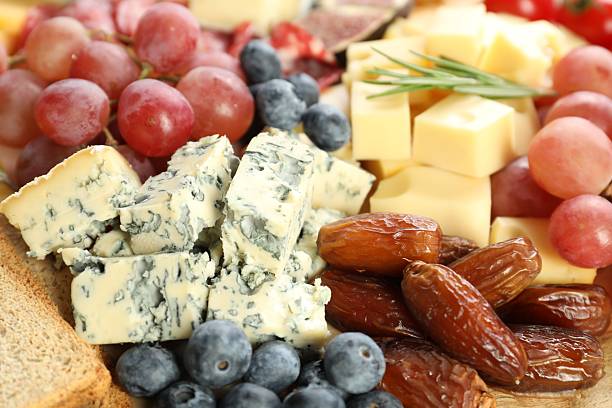 istock Different types of delicious cheese and other snacks as background, closeup 2215179964