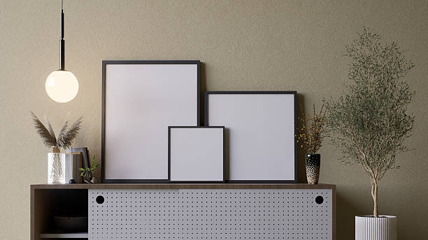 istock A modern interior scene featuring a stylish cabinet with empty picture frames and decorative plants against a muted wall. 3d rendering. 2215180853