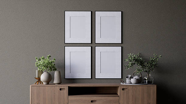 istock A modern interior scene featuring a wooden cabinet adorned with plants, decorative items, and four empty picture frames on the wall for artwork display. 3d rendering. 2215180887