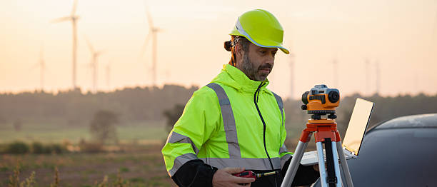 istock A field engineer surveys the land at sunset, with wind turbines behind as technology meets clean energy. 2215180978
