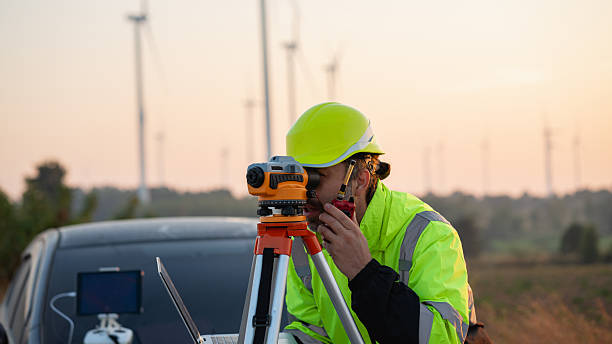 istock A field engineer surveys the land at sunset, with wind turbines behind as technology meets clean energy. 2215181056