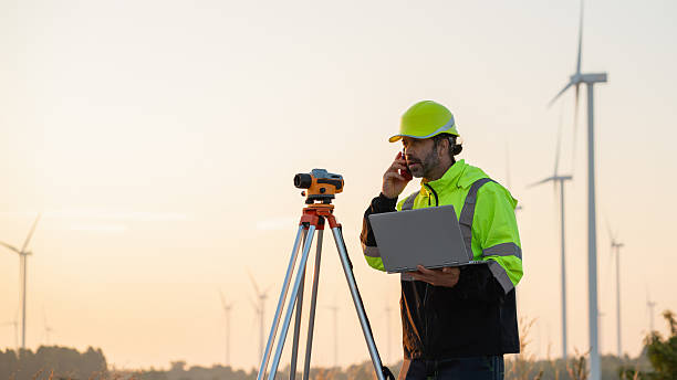 istock A field engineer surveys the land at sunset, with wind turbines behind as technology meets clean energy. 2215181178