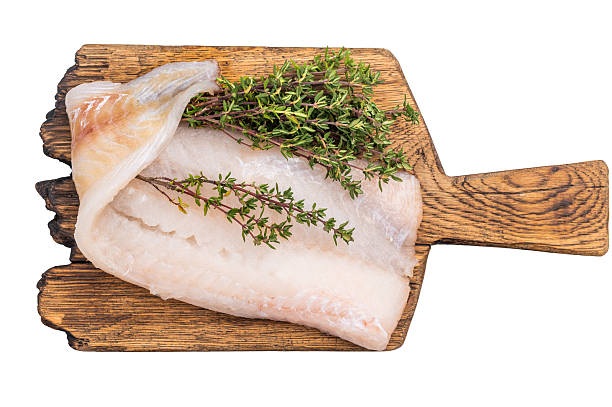 istock Uncooked Atlantic cod fillet, raw fish ready to be seasoned and transformed into a delicious meal. isolated on white background. top view 2215181188