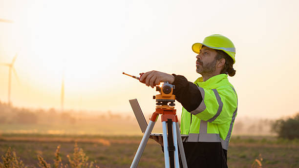 istock A field engineer surveys the land at sunset, with wind turbines behind as technology meets clean energy. 2215181465