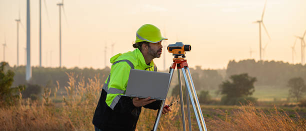 istock A field engineer surveys the land at sunset, with wind turbines behind as technology meets clean energy. 2215181512