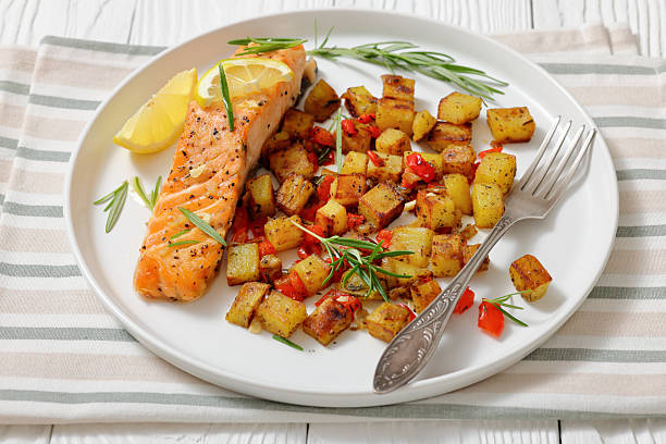 istock Oven-baked salmon fillet with fried potato, lemon 2215181776