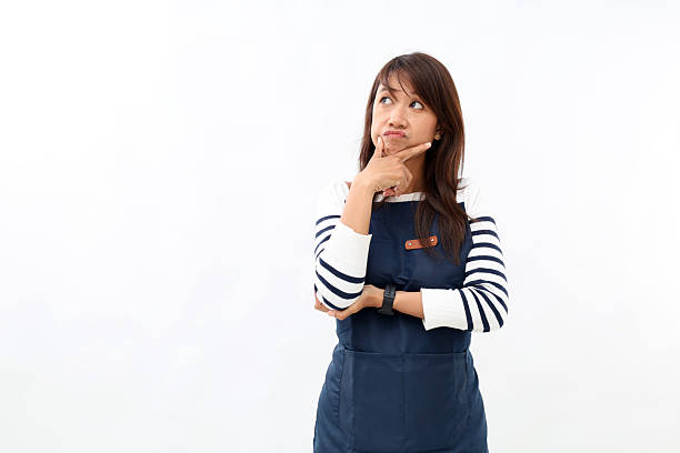 istock Asian woman in apron with curiosity thinking expression. Isolated on white 2215182137