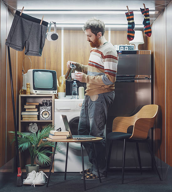 istock Young man having breakfast in his micro apartment 2215182351