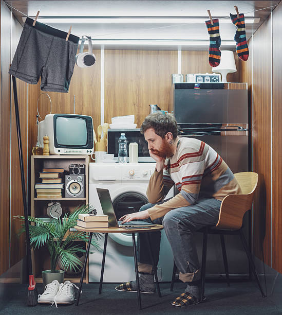 istock Young man living and working in a tiny home 2215182400
