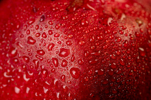 istock a wet red ripe pomegranate on a black table 2215182788