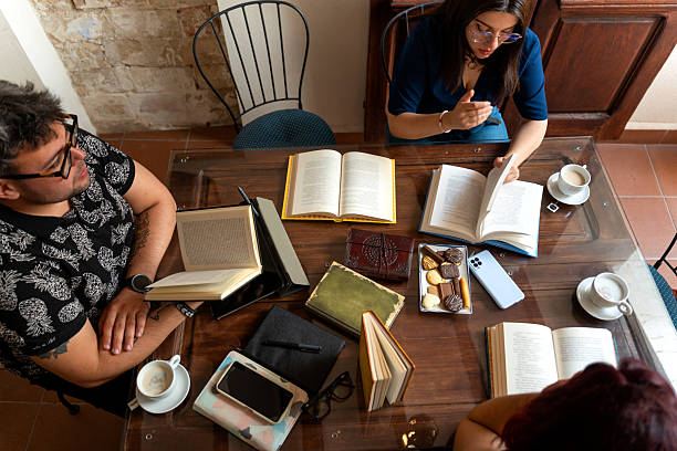 istock Book lovers discussing literature at a cafe table 2215183130