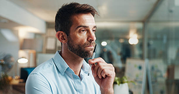 istock Business, thinking and man in office, choice or problem solving with pressure for project. Person, copywriting or employee in workplace, anxiety or confused with doubt for proposal or review feedback 2215183758