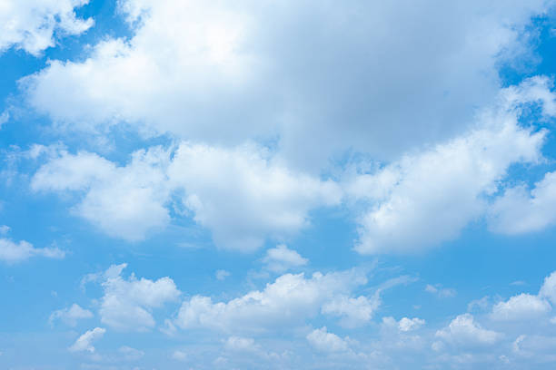 A stunning high-resolution image showcasing a vibrant blue sky adorned with fluffy white cumulus clouds Perfect as a serene background or nature-themed texture for various design projects  The image evokes a sense of peace and tranquility