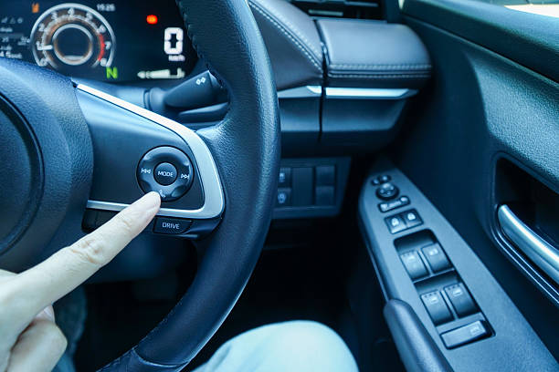 istock interior modern car button on steering wheel with driver hand 2215185839