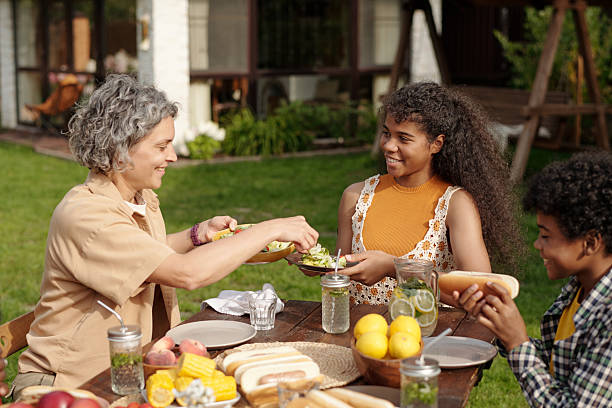 istock Sharing Family Meal Outdoors with Smiling Relatives 2215187004